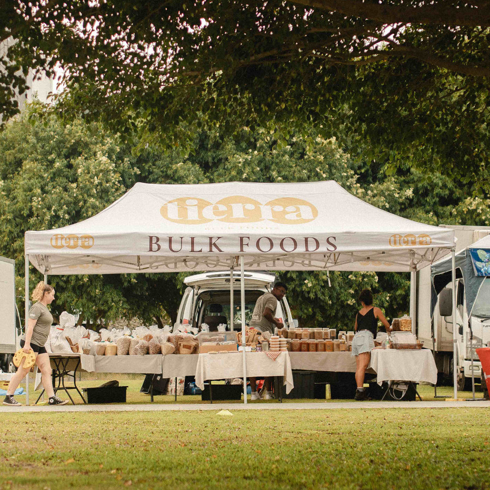 Tierra BULK FOODS 10x20ft Canopy Setup by Flare Shade with Custom Print and Logo